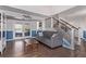 Inviting living room features hardwood floors, a comfortable sofa, and an open staircase at 105 Hawthorn St, Frederick, CO 80530