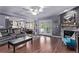 Spacious living room featuring fireplace, hardwood floors, and an open layout to the kitchen and dining area at 105 Hawthorn St, Frederick, CO 80530
