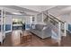 Inviting living room with hardwood floors, a cozy sofa, and an elegant staircase at 105 Hawthorn St, Frederick, CO 80530