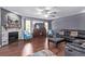 Comfortable living room featuring a stone fireplace, wood accents, and ample seating at 105 Hawthorn St, Frederick, CO 80530
