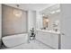 Bathroom with stand alone soaking tub and modern chandelier at 4214 E 8Th Pl, Denver, CO 80220