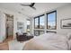 Bright bedroom featuring seating area, ensuite bathroom, and lots of natural light at 4214 E 8Th Pl, Denver, CO 80220