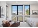 Bedroom featuring lots of natural light and seating area offering a view of city at 4214 E 8Th Pl, Denver, CO 80220