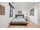 Cozy bedroom with modern decor, a large window, and a minimalist design at 4214 E 8Th Pl, Denver, CO 80220