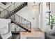 Bright entryway with soaring ceilings, modern staircase, and stylish chandelier at 4214 E 8Th Pl, Denver, CO 80220