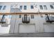 Modern townhome showcasing private balconies and garage access, blending style and functionality at 4214 E 8Th Pl, Denver, CO 80220