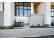 Modern townhome entrance with architectural details and lush landscaping at 4214 E 8Th Pl, Denver, CO 80220