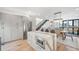 Bright modern kitchen with stainless steel appliances, waterfall island, and adjacent dining area at 4214 E 8Th Pl, Denver, CO 80220