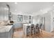 Well-lit modern kitchen featuring a central island, gray cabinets and stainless steel appliances at 4214 E 8Th Pl, Denver, CO 80220