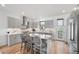 Modern kitchen with stainless steel appliances, waterfall island, and gray cabinets at 4214 E 8Th Pl, Denver, CO 80220