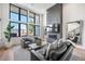 Modern living room with tall windows, fireplace, and comfortable seating arrangement at 4214 E 8Th Pl, Denver, CO 80220