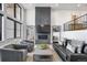 Sophisticated living room featuring a modern fireplace, comfortable seating, and bright windows at 4214 E 8Th Pl, Denver, CO 80220