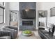 Modern living room featuring a stylish fireplace, contemporary decor, and ample natural light at 4214 E 8Th Pl, Denver, CO 80220