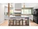 Spacious kitchen featuring a center island, stainless steel appliances, and ample counter space at 3089 S Jasmine St, Denver, CO 80222