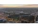 Aerial view showcases the lights of Coors Field and the city skyline at dusk at 1438 Little Raven St # 104, Denver, CO 80202