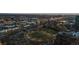 Nighttime aerial view showcases Denver's park, riverfront condos, and city lights at 1438 Little Raven St # 104, Denver, CO 80202