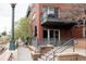 Apartment balcony with seating area, offering stunning views of the surrounding neighborhood at 1438 Little Raven St # 104, Denver, CO 80202