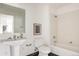 Bright bathroom featuring a pedestal sink, modern fixtures, and a tiled shower-tub combination at 1438 Little Raven St # 104, Denver, CO 80202