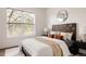 Bedroom with a custom wooden headboard and a light neutral color palette at 1438 Little Raven St # 104, Denver, CO 80202