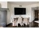 Dining area with dark wood floors, large TV, and seating for six at 1438 Little Raven St # 104, Denver, CO 80202