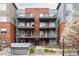 A charming condominium building with brick facade and multiple balconies provides an inviting curb appeal at 1438 Little Raven St # 104, Denver, CO 80202