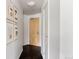Hallway with hardwood floors, stylish artwork, and doors leading to other areas of the residence at 1438 Little Raven St # 104, Denver, CO 80202