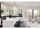 Bright kitchen featuring a large island, stainless steel appliances, and modern pendant lighting at 1438 Little Raven St # 104, Denver, CO 80202