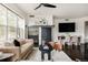 Bright living room features a modern fireplace, adjacent dining space, and large windows at 1438 Little Raven St # 104, Denver, CO 80202
