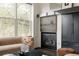 Living room showcasing a fireplace with custom dark gray cabinetry at 1438 Little Raven St # 104, Denver, CO 80202