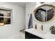 Stylish bathroom with a gold-trimmed mirror, marble countertop, and modern fixtures at 520 Columbine St, Denver, CO 80206