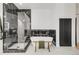 Stylish bathroom featuring a glass shower, a modern tub, and chic black marble tiling at 520 Columbine St, Denver, CO 80206