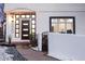 Modern front entrance with a dark door and a brick walkway at 520 Columbine St, Denver, CO 80206