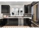 Modern kitchen with black cabinetry, stainless steel appliances, and quartz countertops at 520 Columbine St, Denver, CO 80206