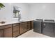 Laundry room with modern washer and dryer, and ample counter space at 520 Columbine St, Denver, CO 80206