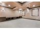 Spacious finished basement featuring built-in cabinets, neutral carpet, and modern lighting fixtures at 8680 Summerlin Pl, Longmont, CO 80503