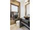 Stylish bathroom featuring a vessel sink, granite countertop, and unique gold hexagon tiled accent wall at 8680 Summerlin Pl, Longmont, CO 80503