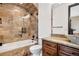 Bathroom showcasing stone tile surround, bathtub, and granite countertop vanity with vessel sink at 8680 Summerlin Pl, Longmont, CO 80503