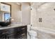 Updated bathroom with marble tile, glass-enclosed shower, and modern vanity at 8680 Summerlin Pl, Longmont, CO 80503