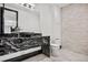 Modern powder room featuring a unique granite vanity, bowl sink, and eye catching stone accent wall at 8680 Summerlin Pl, Longmont, CO 80503