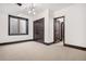 Neutral bedroom with a large window and decorative wood doors at 8680 Summerlin Pl, Longmont, CO 80503