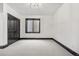 Bright bedroom with neutral carpet, a large window, and dark wood trim at 8680 Summerlin Pl, Longmont, CO 80503