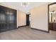 Spacious bedroom with hardwood floors, modern lighting, and large closet provides a calming retreat at 8680 Summerlin Pl, Longmont, CO 80503