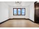 Bright bedroom featuring hardwood floors, and black trim on windows and baseboards at 8680 Summerlin Pl, Longmont, CO 80503