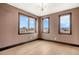 Bedroom with large windows offering beautiful neighborhood and mountain views at 8680 Summerlin Pl, Longmont, CO 80503