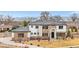 Elegant two-story home featuring stone accents, a well-manicured lawn, and mountain views at 8680 Summerlin Pl, Longmont, CO 80503