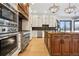 Gourmet kitchen boasts stainless steel appliances and large center island with granite countertops at 8680 Summerlin Pl, Longmont, CO 80503