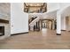 Grand living space featuring curved staircase, fireplace, and elegant archways at 8680 Summerlin Pl, Longmont, CO 80503