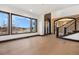 Bright living room with large windows, wood floors, and a decorative front door at 8680 Summerlin Pl, Longmont, CO 80503