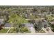 An aerial view of a landscaped front yard, driveway, mature trees and view of the street at 6150 S Southwood Dr, Centennial, CO 80121