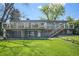 Spacious backyard with lush green lawn, a deck, a patio, and landscaping at 6150 S Southwood Dr, Centennial, CO 80121